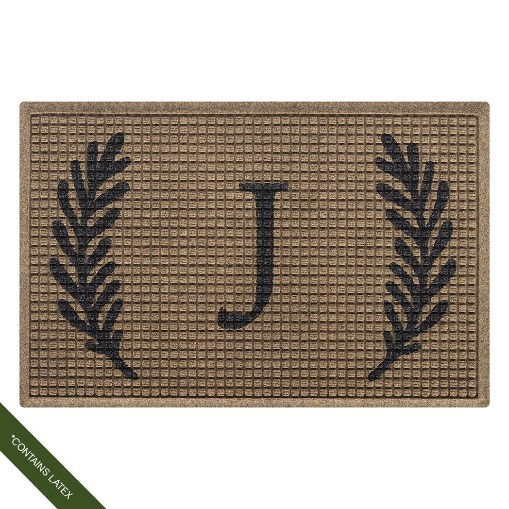 Single-door charcoal WaterHog Squares doormat personalized with a capitalized serif 'J' in charcoal with a laurel design; latex declaimer