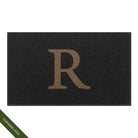 Large charcoal WaterHog Squares doormat personalized with a capitalized serif 'R' in a light tan color in the center of the mat; latex declaimer