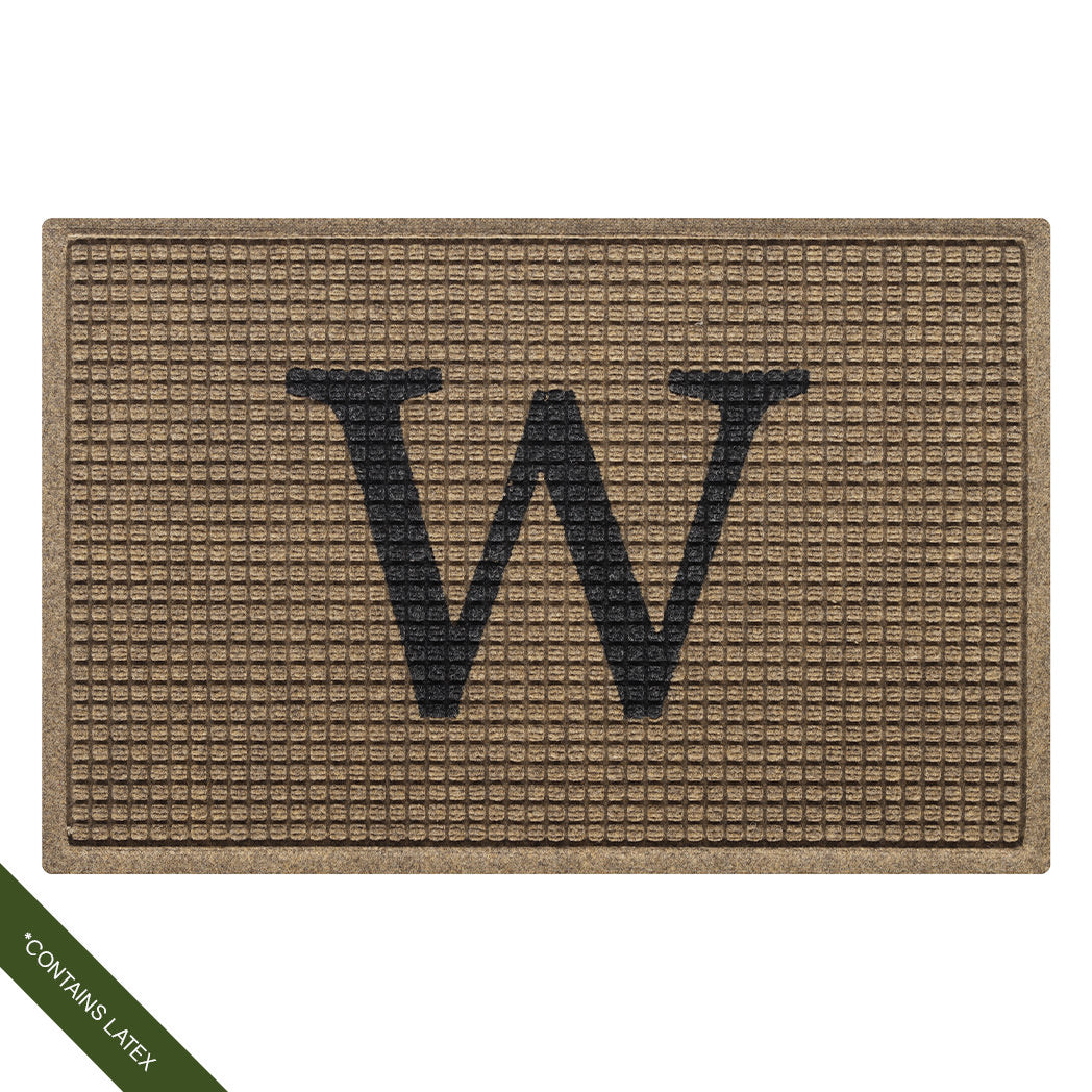 The original WaterHog Squares doormat in camel monogrammed with a serif capital 'W' in charcoal in the center; latex disclaimer