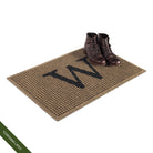 Single door WaterHog Inlay doormat monogrammed with 'W' with a pair a leather boots to show the size; latex disclaimer