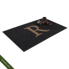 Large WaterHog Inlay doormat monogrammed with 'R' with a pair a leather boots to show the size; latex disclaimer