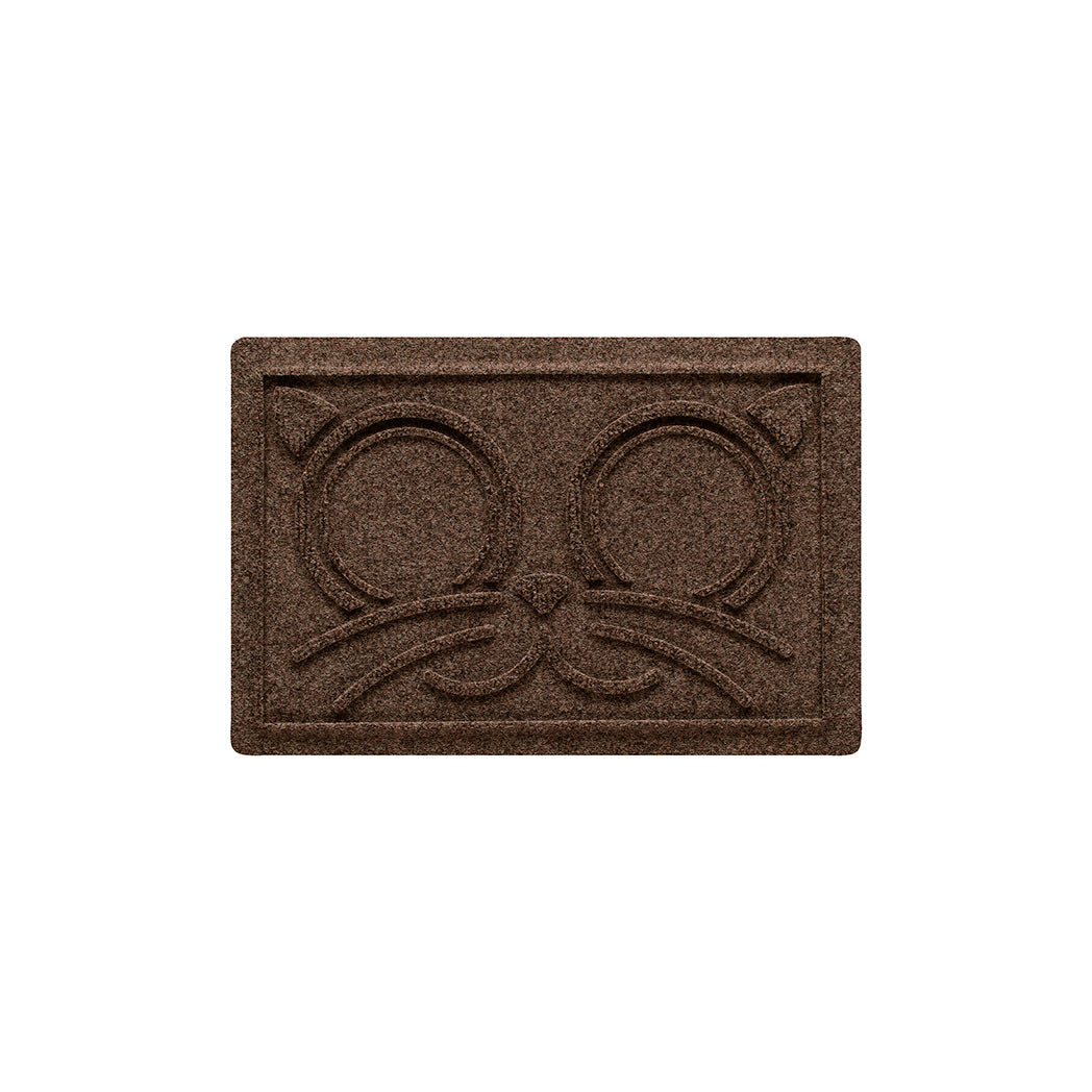 Overhead of a small WaterHog Kitty Face bowl mat in a dark earthy brown surface.