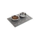 Angled small WaterHog Kitty Face bowl mat in medium grey with two dog dishes on top.