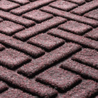 Close-up of Lattice's surface fibers made of deep wine red, white, and grey fibers making an interlocking elliptical design.