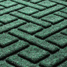 Close-up of the fade-resistant WaterHog Lattice fibers made of green, white, and grey creating a interlocking elliptical design.