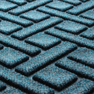 Close-up of the all-weather WaterHog durable surface fibers made of dark and light blues, white and grey strands.