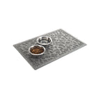 Angled Paws & Bones bowl mat in camel with a pet water and food bowl on top all on a white background.