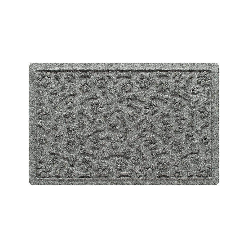 An 18x28 WaterHog Paws & Bones bowl mat overhead, in a light grey surface and durable rubber backing.