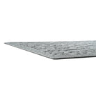 A side-profile shot of the WaterHog Paws & Bones indoor/outdoor mat in light grey, displaying the low-profile properties of the mat.