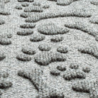 A zoomed-in shot of the WaterHog Paws & Bones all-weather doormat in light grey, displaying the the carpet fibers that make up the elevated design.