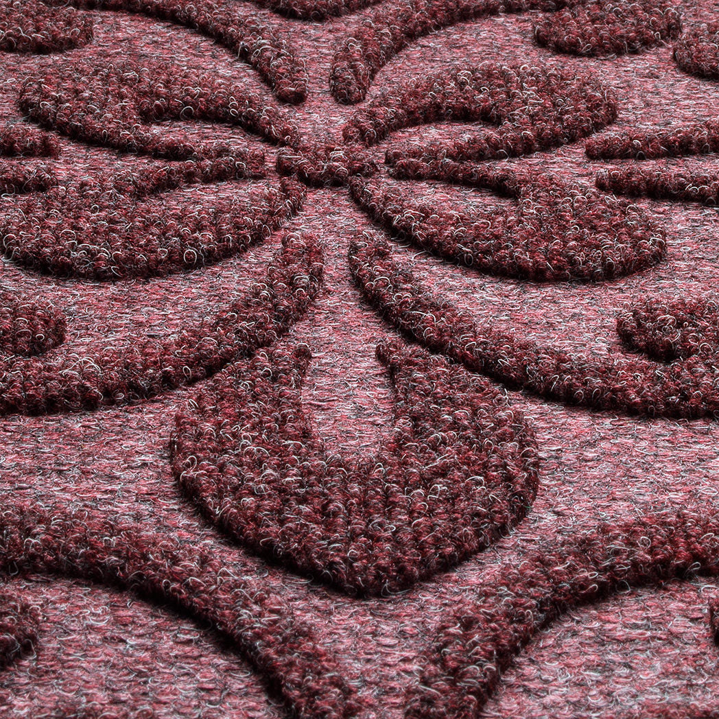 A close-up shot of the WaterHog Pheonix Indoor/Outdoor doormat in a burgundy, displaying the mixture of dark red, grey, and white carpeted fibers that make up the top of the mat.