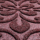 A close-up shot of the WaterHog Pheonix Indoor/Outdoor doormat in a burgundy, displaying the mixture of dark red, grey, and white carpeted fibers that make up the top of the mat.