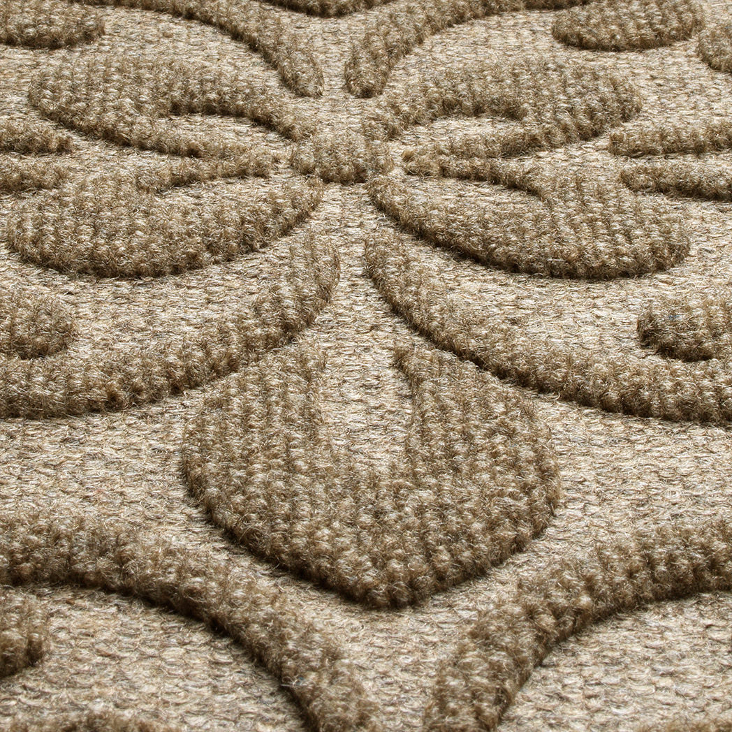 A close-up shot of the WaterHog Pheonix Indoor/Outdoor doormat in tan, displaying the mixture of tan, grey, and white carpeted fibers that make up the top of the mat.