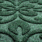 A close-up shot of the WaterHog Pheonix Indoor/Outdoor doormat in a deep green, displaying the mixture of green, grey, and white carpeted fibers that make up the top of the mat.