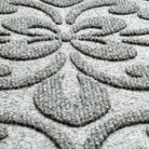 close-up shot of the WaterHog Pheonix Indoor/Outdoor doormat in light grer, displaying the mixture of grey and white carpeted fibers that make up the top of the mat.