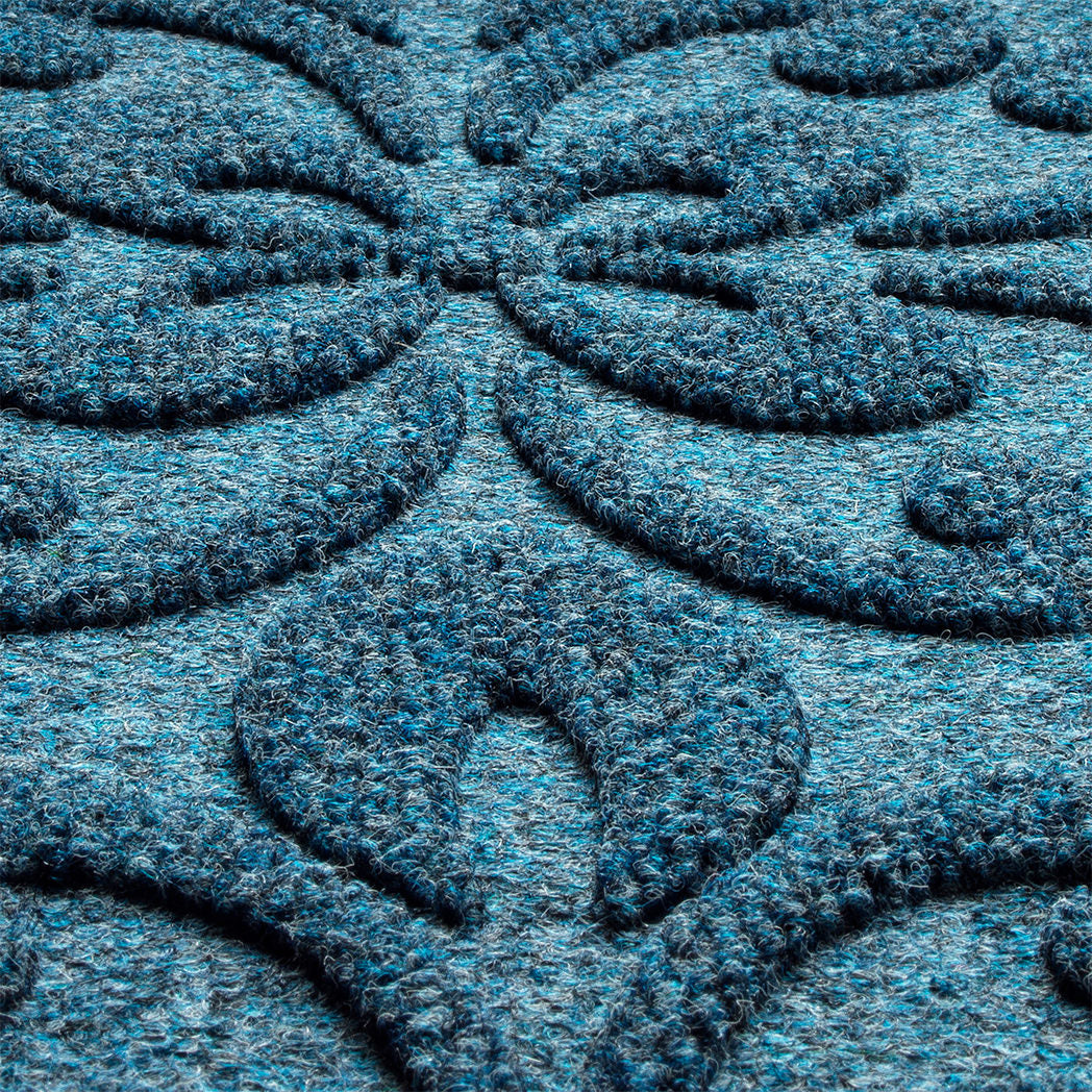 A close-up shot of the WaterHog Phoenix Indoor/Outdoor doormat in a 
navy blue, displaying the mixture of blue, grey, and white carpeted fibers that make up the top of the mat.