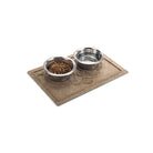 Angled small WaterHog Puppy Face bowl mat in camel with two small dog dishes on top.