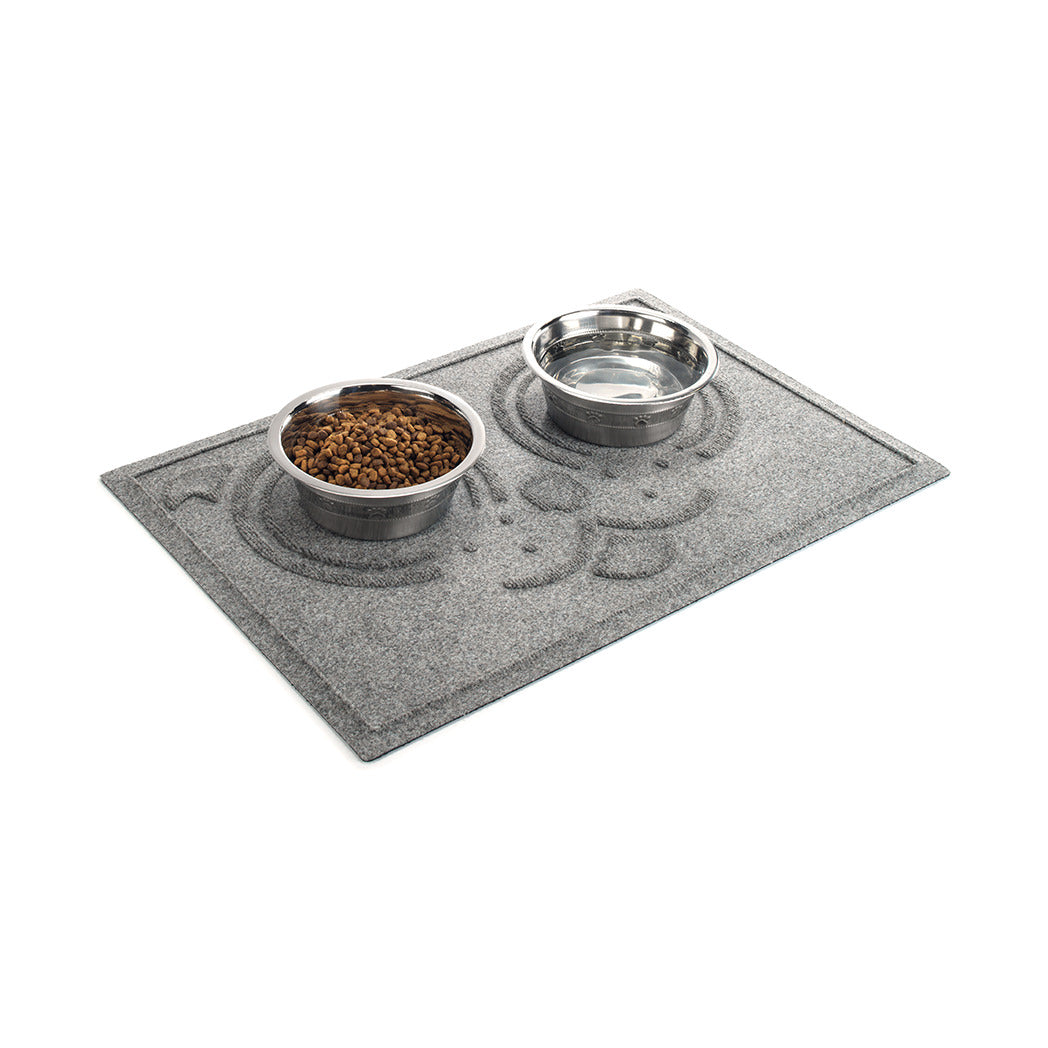 Angled WaterHog Puppy Face large bowl mat in medium grey with two dog dishes all on a white background.