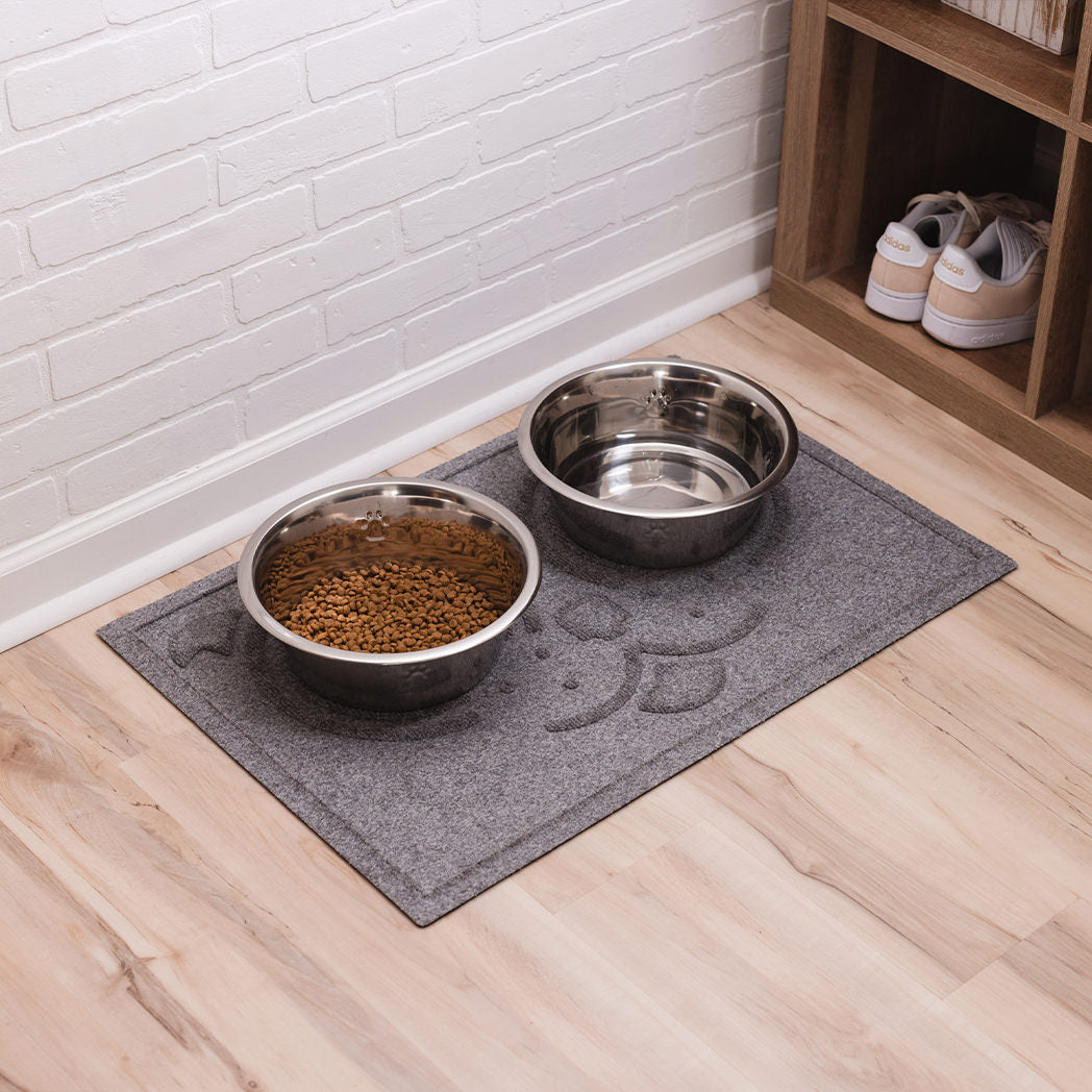 A large, medium grey Puppy Face WaterHog mat in a mud room for protection from messy, drooly puppies.