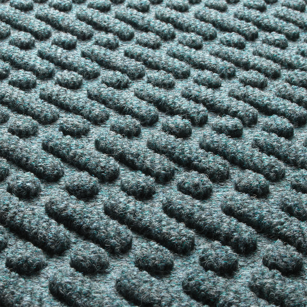 Detail shot of the all-weather Sentry WaterHog's durable, eco-friendly fibers made of light blue, grey, and white fibers.