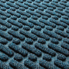 Close-up of the all-weather WaterHog durable surface fibers made up of dark and light blues, white and grey strands.