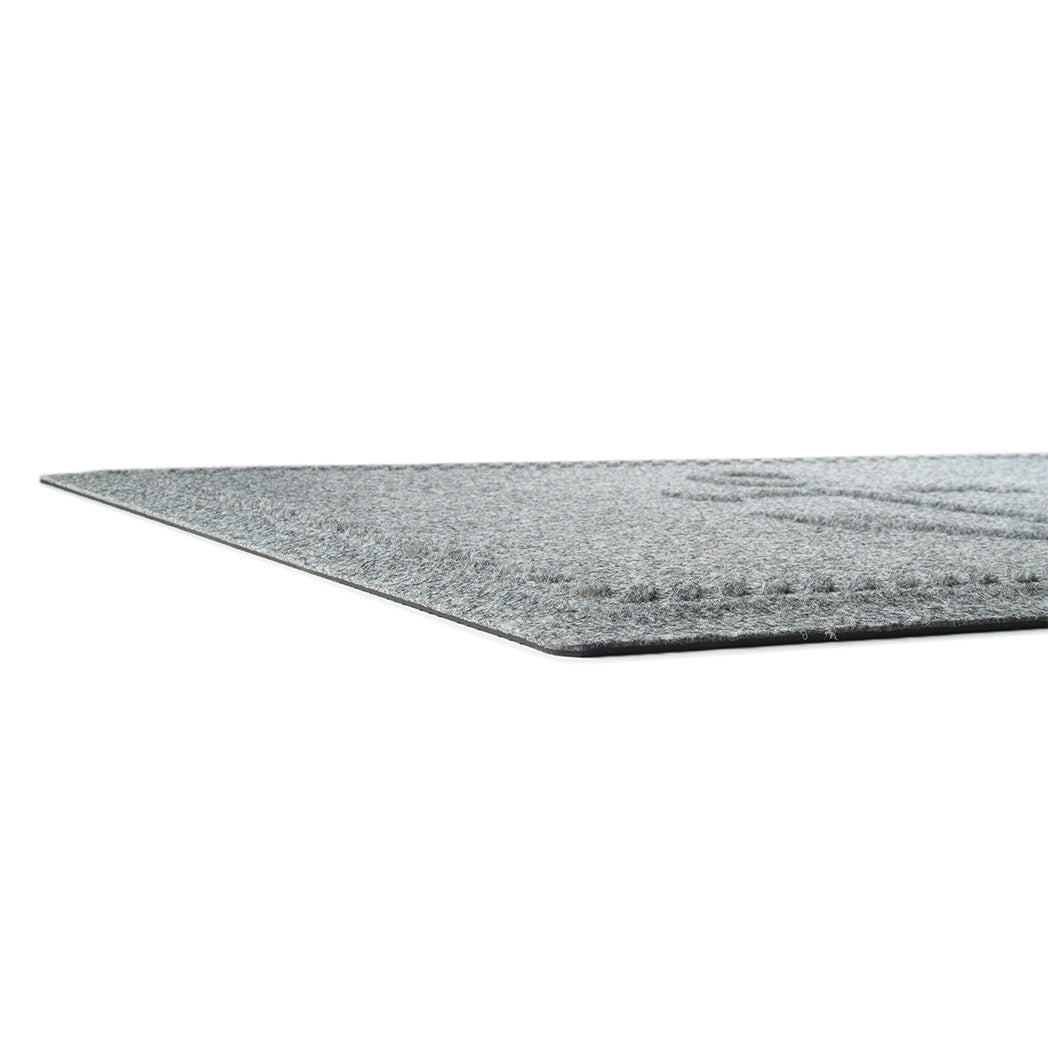 A side-profile shot of the WaterHog Ship's Anchor durable doormat in light grey, highlighting the low-profile property of the mat.