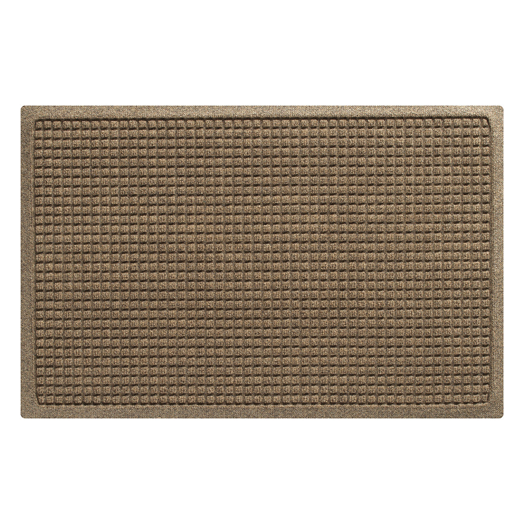 Overhead of a medium Squares indoor/outdoor doormat in a light tan color and uniform grid, bi-level design.