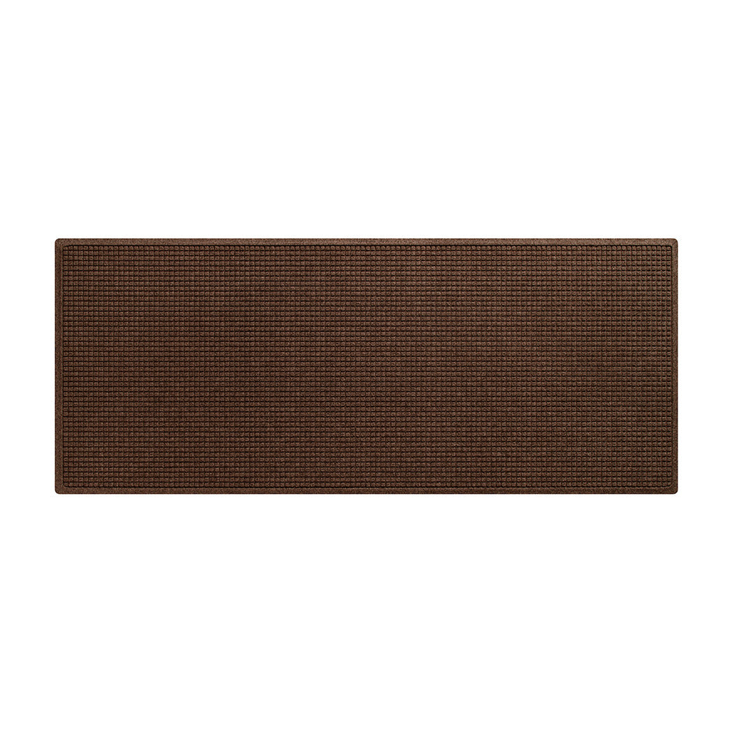 An overhead of a WaterHog Squares dark brown runner made with an eco-friendly surface and backed by durable rubber, shown on a white background.