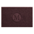 A monogrammed WaterHog Squares indoor doormat with a deep wine red, fade-resistant surface, all made in the USA.