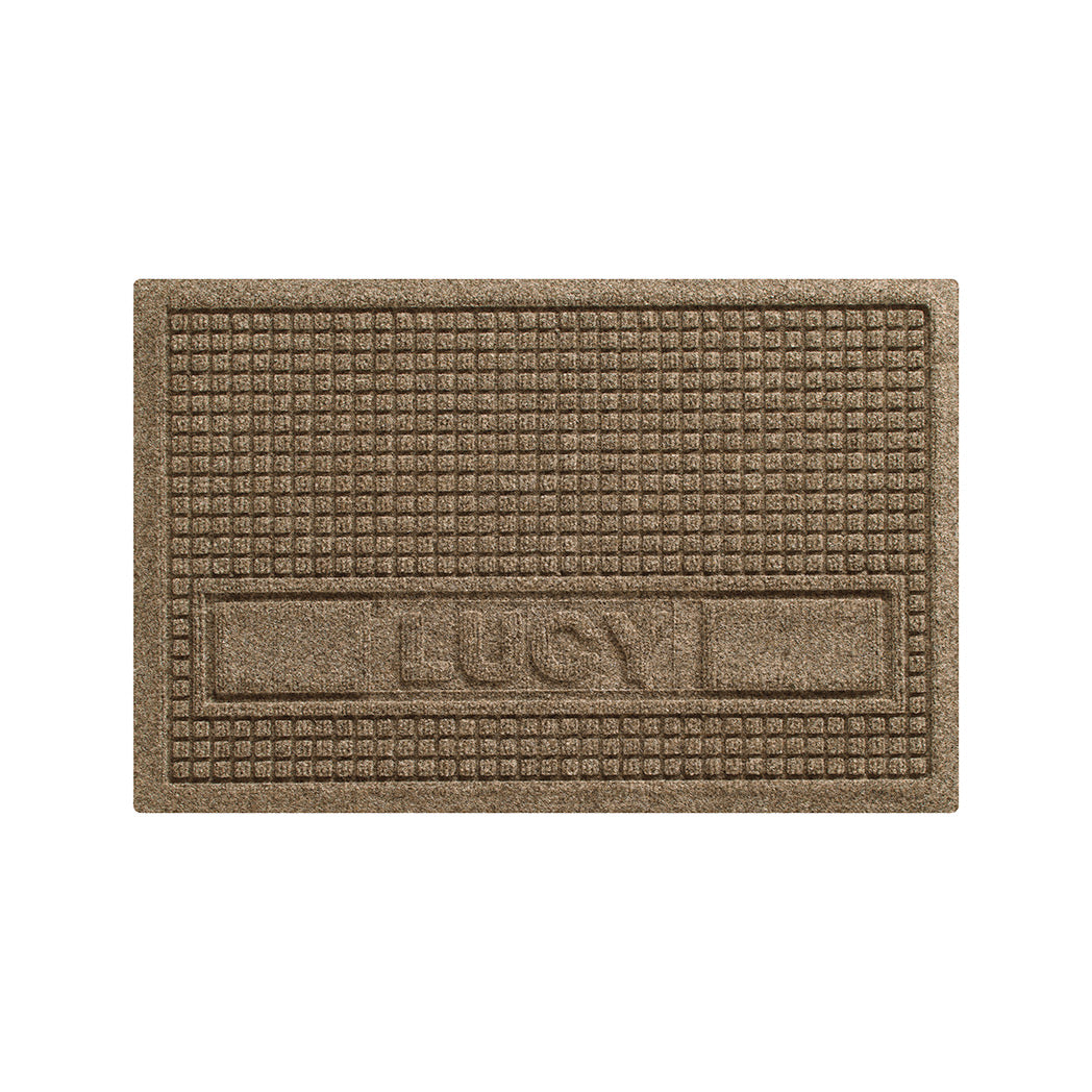 Overhead of a WaterHog Sqaures pet mat personalized with an all-caps Bailey in the lower center of the mat, with two rectangular blocks on the side, in a tan, bi-level surface.