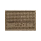 Overhead of a WaterHog Sqaures pet mat personalized with an all-caps Bailey in the lower center of the mat, with two rectangular blocks on the side, in a tan, bi-level surface.