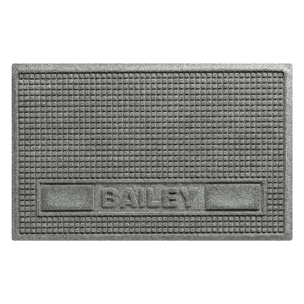 Overhead of medium WaterHog personalized mat, in the gey Squares design, with the name Bailey in all caps in the lower center of the mat, with two medium rectangular blocks on the side.