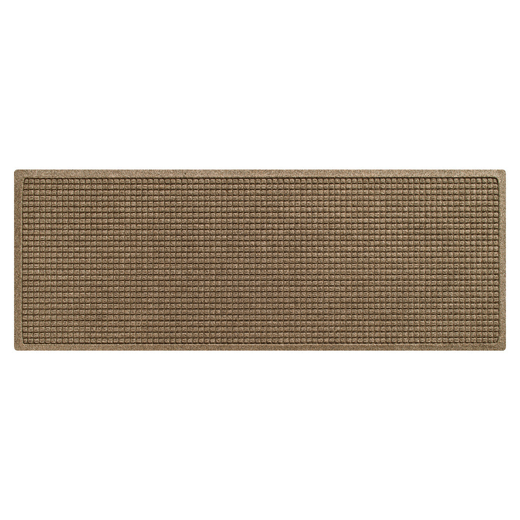 Overhead image of a grid-like patterned indoor/outdoor small runner mat light a light tan color and bi-level design to reduce tracking dirt, debris, and moisture into your home.