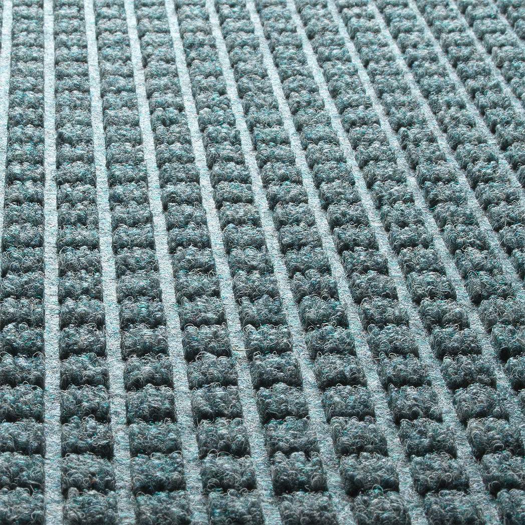 A close-up detailed shot of WaterHog  Square's eco-friendly PET surface, made of light blue, grey, white, and some green polyester fibers.