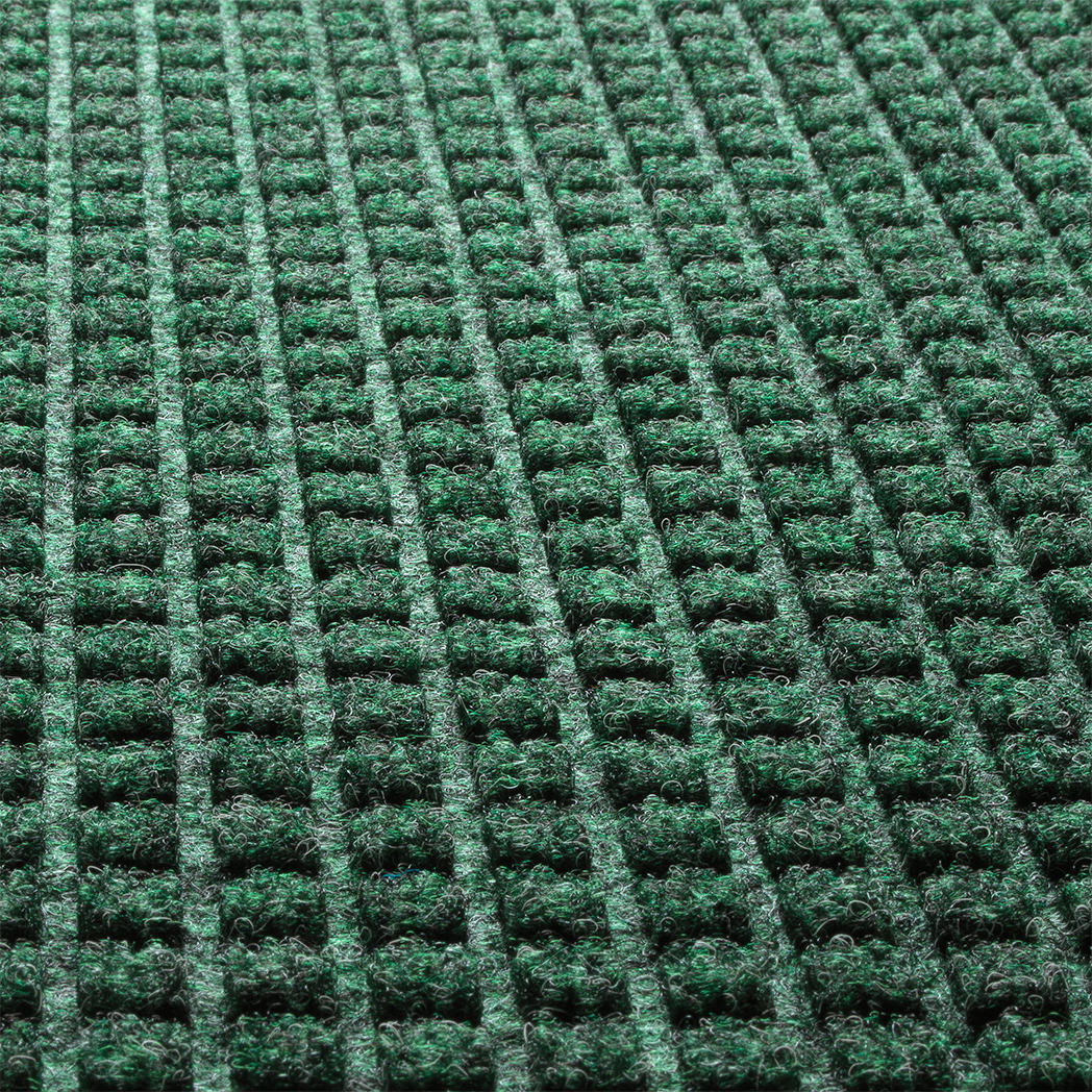 Close-up of the stain-resistant WaterHog PET surface made of green, white, and grey creating a modern repeating squares design.