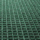 Close-up of the stain-resistant WaterHog PET surface made of green, white, and grey creating a modern repeating squares design.