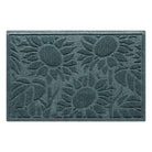 An overhead image of a single-door WaterHog Sunshine Day cute doormat, which features a bi-level design of three sunflowers surrounded by leaves, made to help protect against tracking of mud, dirt, or moisture throughout your home.