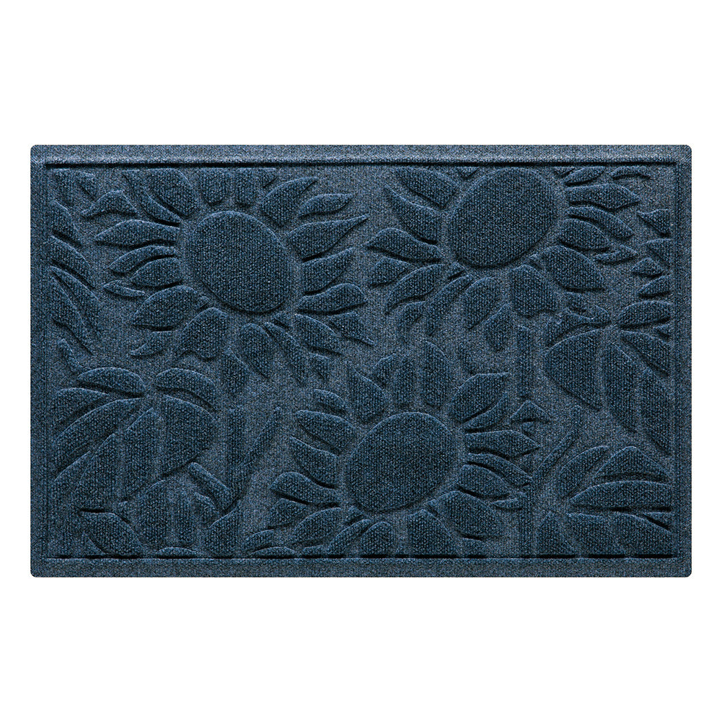 A classic navy WaterHog Sunshine Day doormat featuring a sunflower design with three large sunflowers, surrounded by leaves and stems, creating a novelty doormat that effectively scrapes and traps dirt and moisture from shoes.