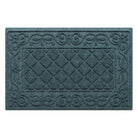 A medium Tristan WaterHog modern doormat in a dusty light blue that features the design of the classic diamond that is boarded by an ornate scroll design, all encased by a water dam border for holding water off your floors.