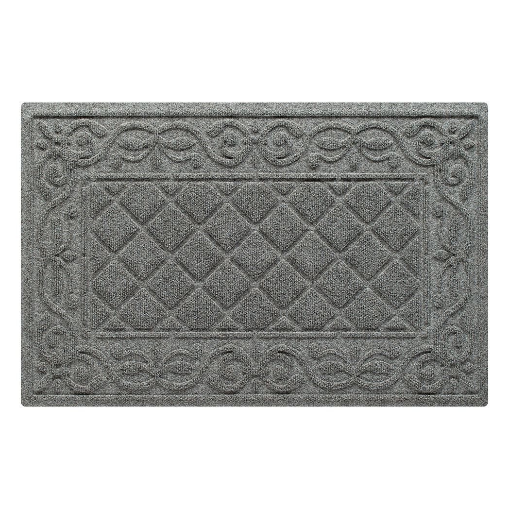 An overhead view of a classic medium grey Tristan doormat, which features an ornate scrollwork pattern that borders the classic, squared-off diamonds pattern in the center, in a single-door size, shown on a white background.