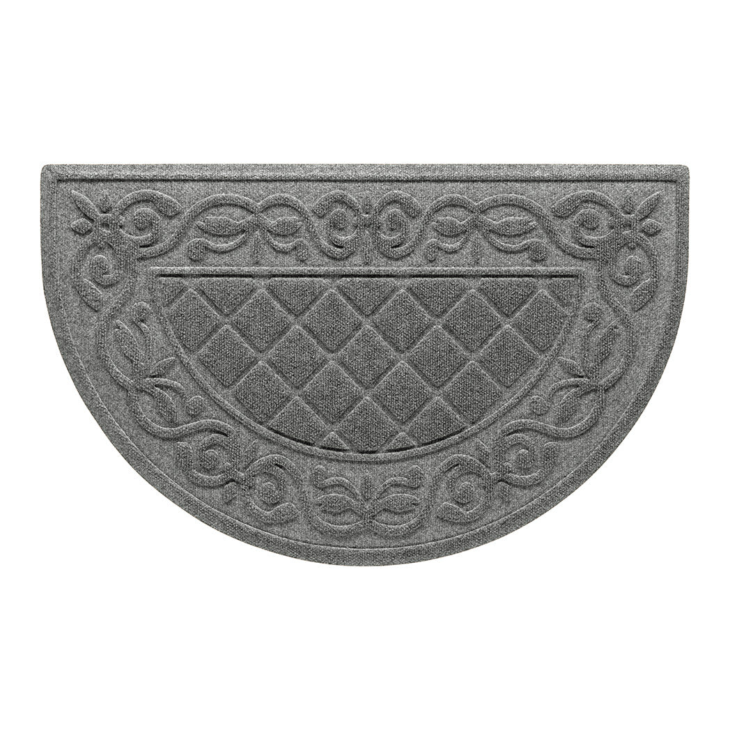 An overhead view of a classic medium grey Tristan Half-Round doormat, which features an ornate scrollwork pattern that borders the classic, squared-off diamonds pattern in the center, shown on a white background.