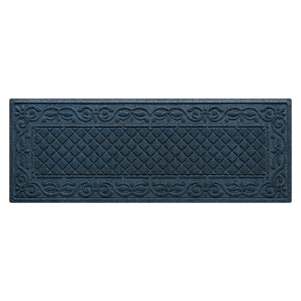 A WaterHog Tristan Runner door mat in a deep navy color with a two-part design - an ornate scroll pattern boarding the classic diamonds pattern - all backed by durable rubber backing.