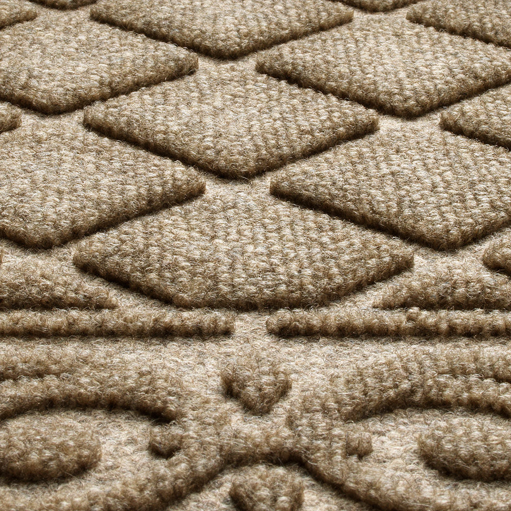 Detailed shot of WaterHog's Tristan doormat's bi-level surface, showing the eco-friendly fibers of various tans, yellows, and whites, blending to make a fade and stain-resistant camel color.