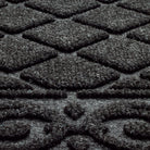 Extreme close-up of a charcoal Tristan bi-level surface doormat made for aggressive scrapping and trapping dirt and moisture below show level to help prevent tracking through your house.