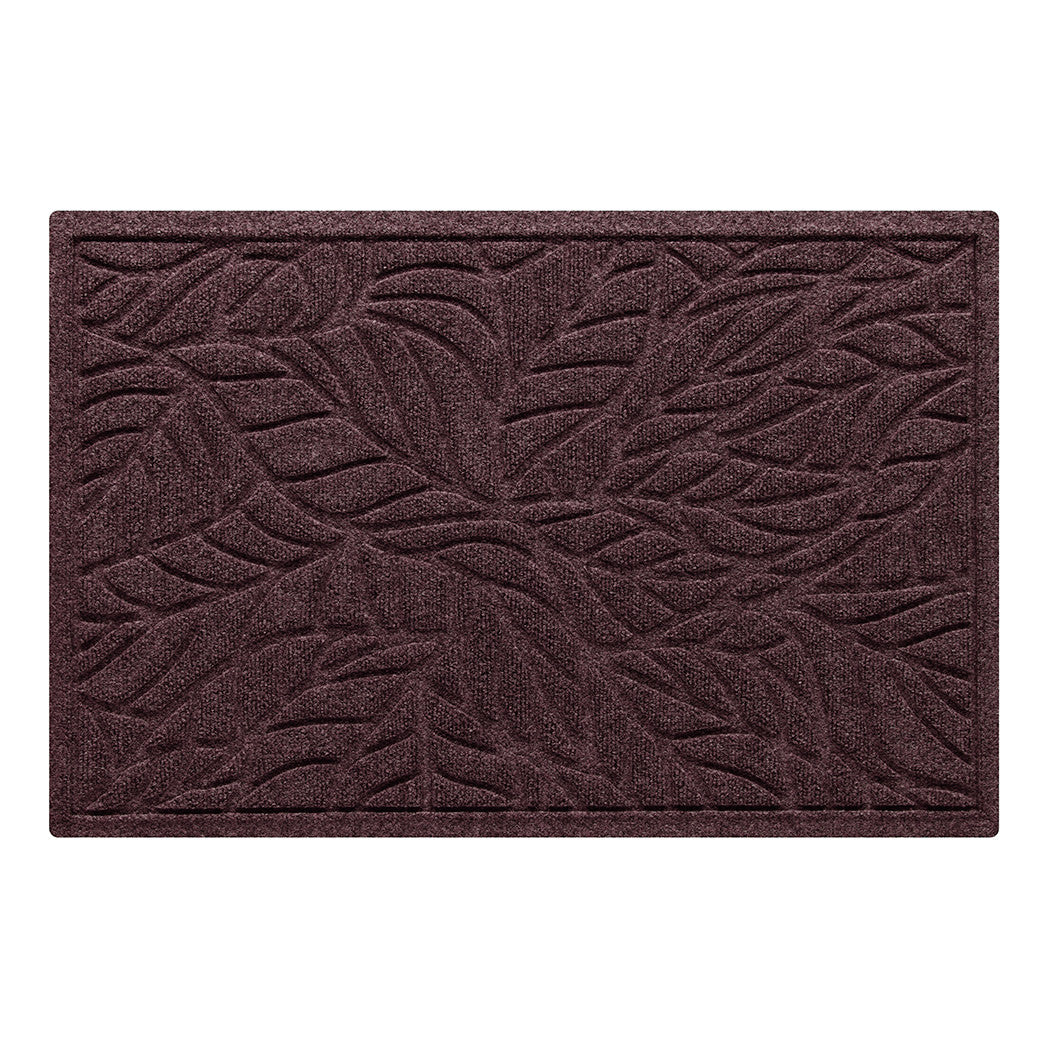 A medium WaterHog doormat in a dark wine color with a bi-level tropical leaf designed to trap dirt and moisture while the water damn border holds water off floors for protection.