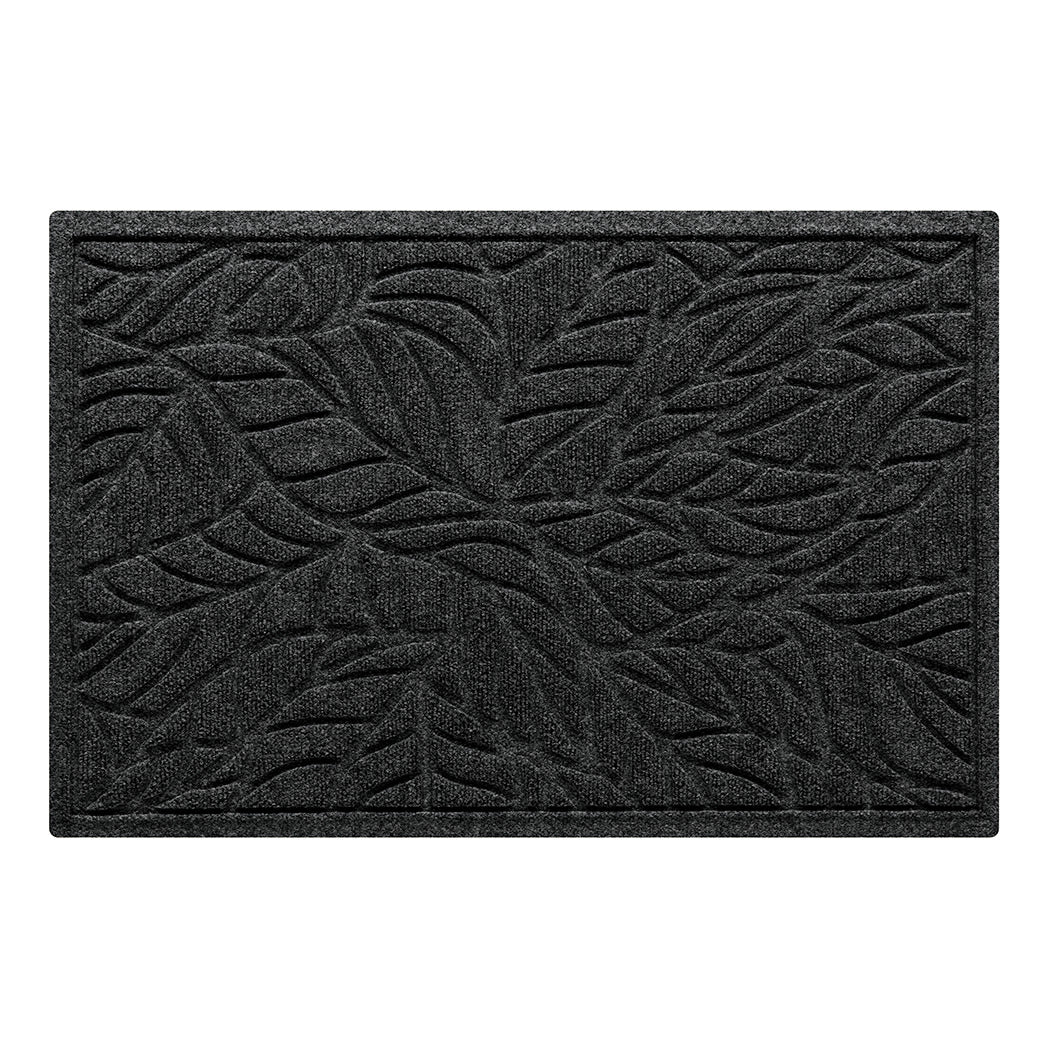 An overhead view of a medium WaterHog doormat in a deep grey color with a bi-level tropical leaf design and a raised border shown on a white background.